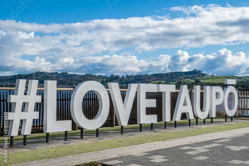 Hashtag Love Taupo sign in front of Lake Taupo in New Zealand. photo