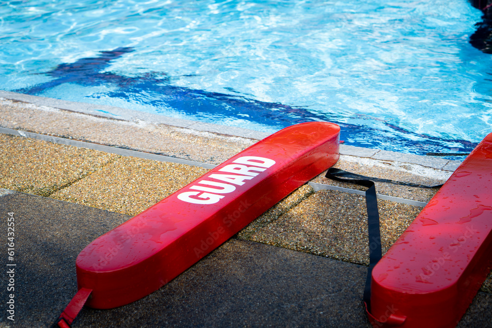 Swimming training tool. Red plastic block tied with rope for saving life at swimming pool. Swimming training tool. Red plastic block tied with rope for saving life at swimming pool.