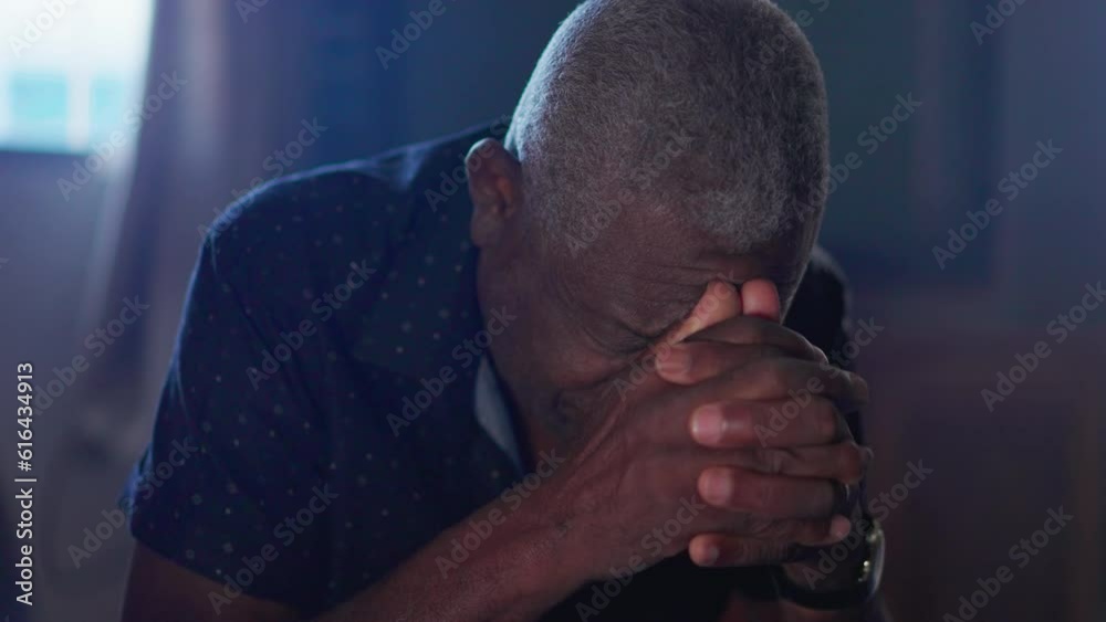 Close-up of Devout Black Senior Man in Prayer Seeking God's help. Elderly African American person on his knees with hands clenched Close-up of Devout Black Senior Man in Prayer Seeking God's help. Elderly African American person on his knees with hands clenched