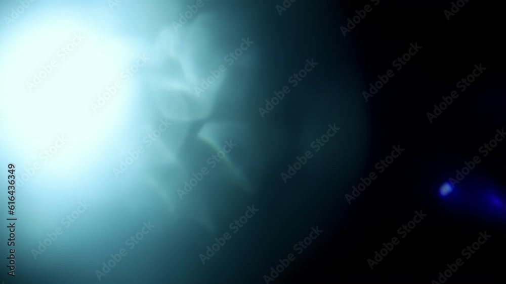 Beam of light with blue leaks and bokeh highlights moving to right on black background for transitions and overlay effects.