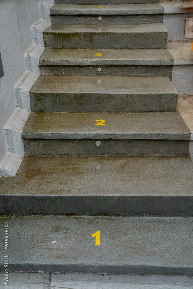 Numbered concrete stairs in rainy conditions Numbered concrete stairs in rainy conditions