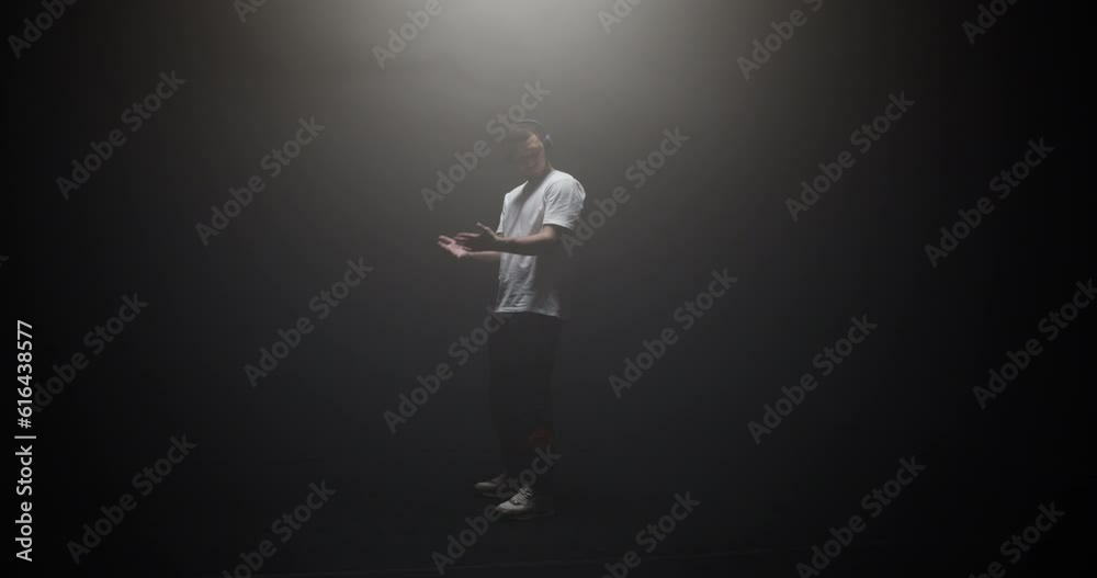 Freestyle dancer performing in spotlight Freestyle dancer performing in spotlight