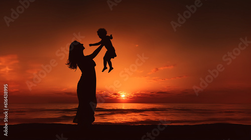 Silhouette of mother and child playing on a beach during sunset  © TimeaPeter