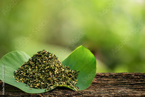 Dried young plant in the lotus seeds on lotus green leaf background.