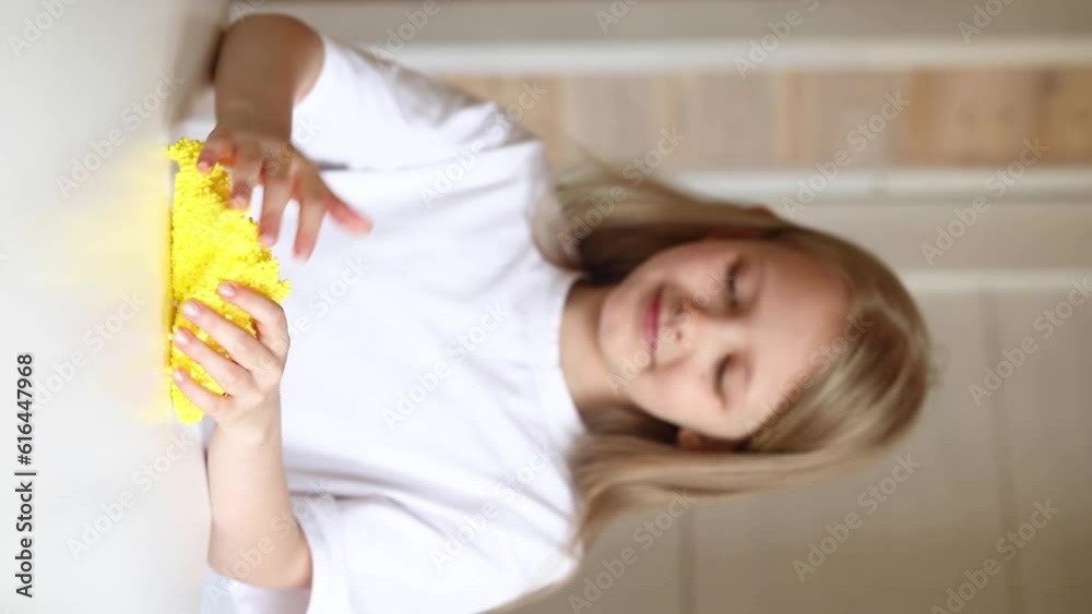 Girl playing with yellow slime. Antistress toy for children. The girl stretches the slime. Vertical video Girl playing with yellow slime. Antistress toy for children. The girl stretches the slime. Vertical video