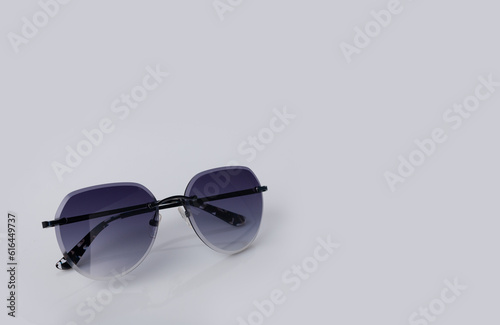 gray glasses in a metal frame on a light background, copy space
