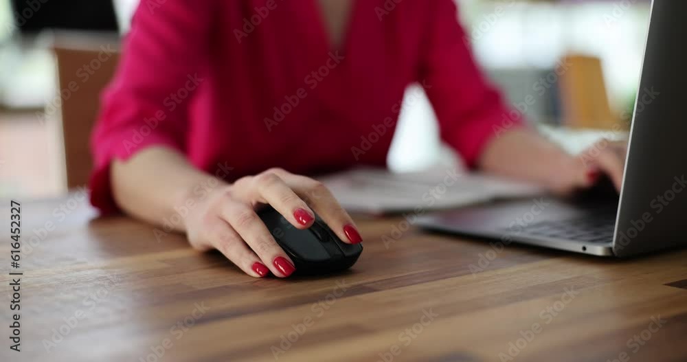 Woman use computer mouse working on computer at table closeup. Remote work freelance and IT career
