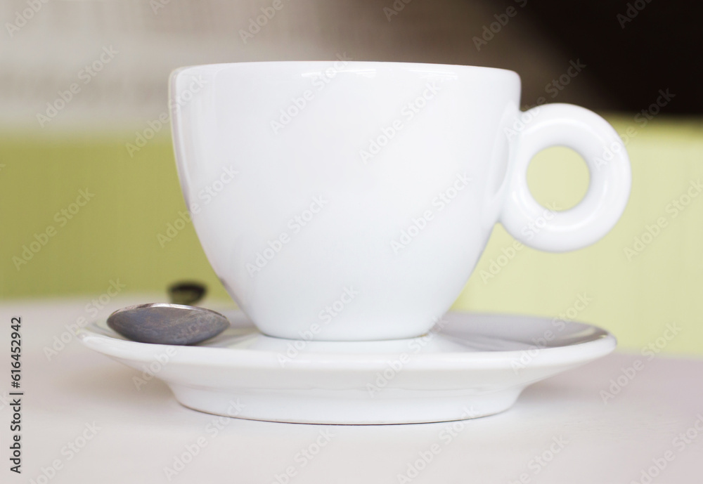 Closeup, white cup and saucer in cafe, coffee shop and order for hot drinks beverage. Background, table crockery and teacup for drinking latte, cappuccino and espresso in restaurant or food industry Closeup, white cup and saucer in cafe, coffee shop and order for hot drinks beverage. Background, table crockery and teacup for drinking latte, cappuccino and espresso in restaurant or food industry