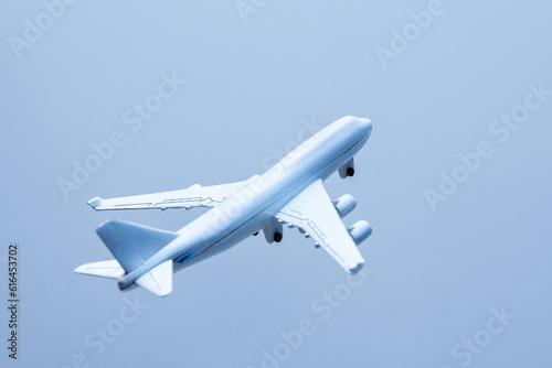Airplane in the blue sky, closeup of photo with soft focus