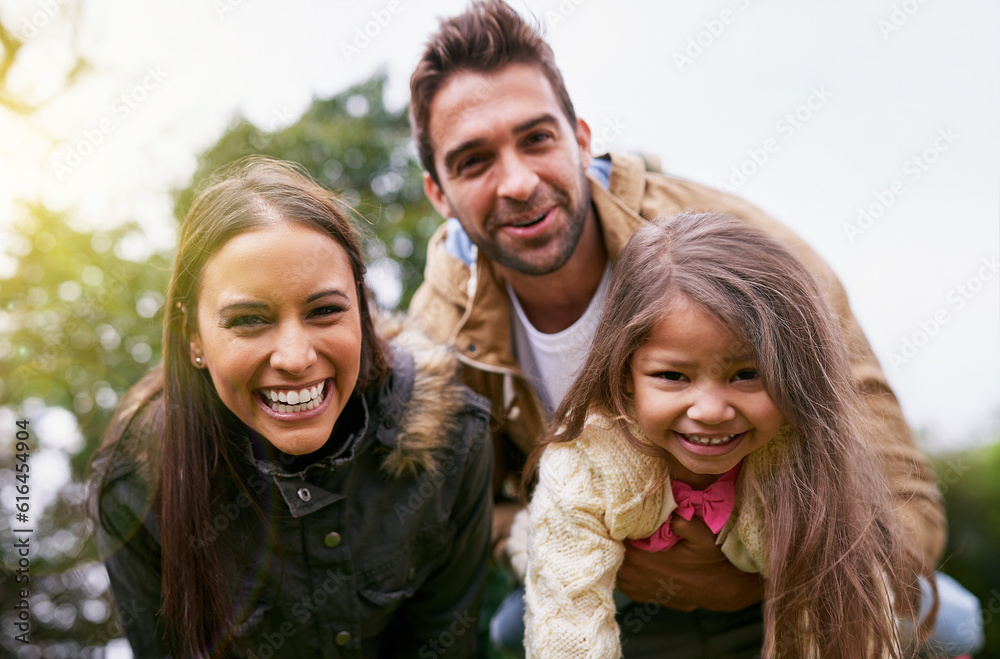 Family, laughing and park with face of parents, dad and girl together with mom and smile. Outdoor, portrait and vacation of a mother, father and kid with bonding, parent love and young child care