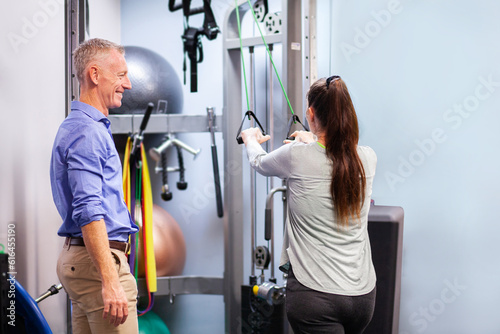 Physiotherapist working with client in clinic to recover from an injury photo