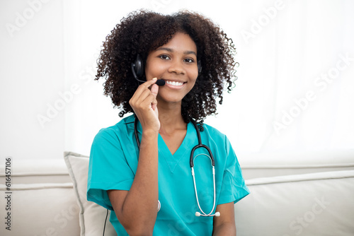Shot of Africa American female doctor talking with colleagues through a video call with a laptop in the consultation. Home health care concept.