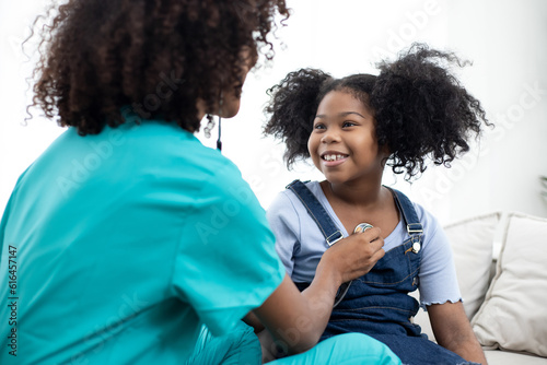 Doctor use stethoscope, checking up heart beat of little girl, auscultation special at home. One stop service. Child people cardiology healthcare concept