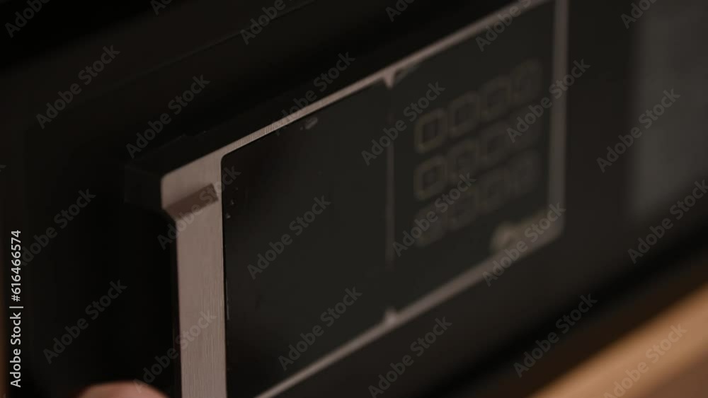 Man hand with a metal strongbox door close up. Unknown person entering numbers combination on electronic panel to lock modern safe. Male fingers pressing locker buttons using correct passcode. Man hand with a metal strongbox door close up. Unknown person entering numbers combination on electronic panel to lock modern safe. Male fingers pressing locker buttons using correct passcode.