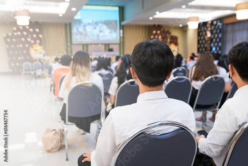 College students listening to seminar lectures in the hall