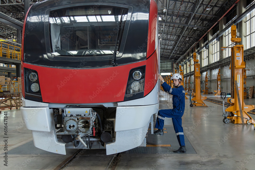 Engineer checks spare parts list and maintains mass transit locomotives in Asia