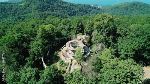 Aerial view of the abandoned building of the former restaurant among the trees on the top of Mount Akhun, Sochi, Russia. photo