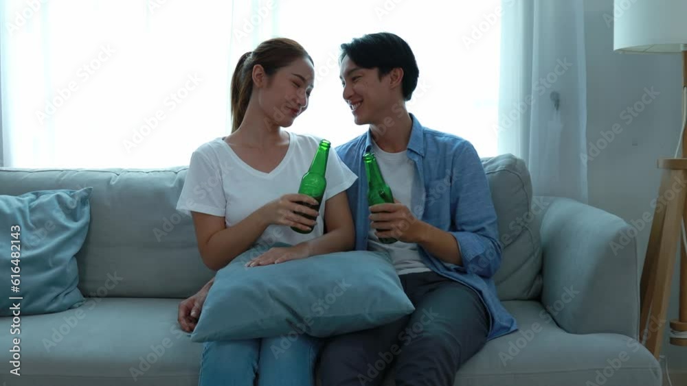 Young couple watching tv series laughing happily using tablet and sitting on sofa bed
Young couple watching tv series laughing happily using tablet and sitting on sofa bed