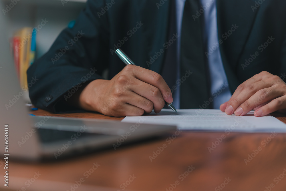 person document writing on paper with a pen, Man worker signing job contract, note, insurance and report concept. person document writing on paper with a pen, Man worker signing job contract, note, insurance and report concept.
