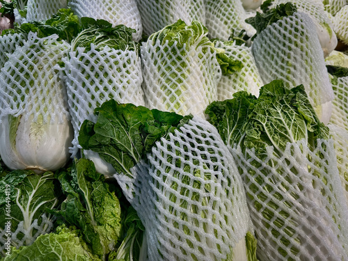 Pile of Wrapped Lettuces for Sale at Supermarket