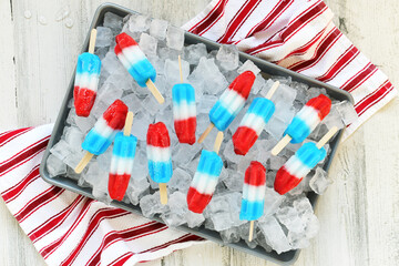 Red white & blue popsicles on tray of ice for serving at summer party patriotic rocket pops