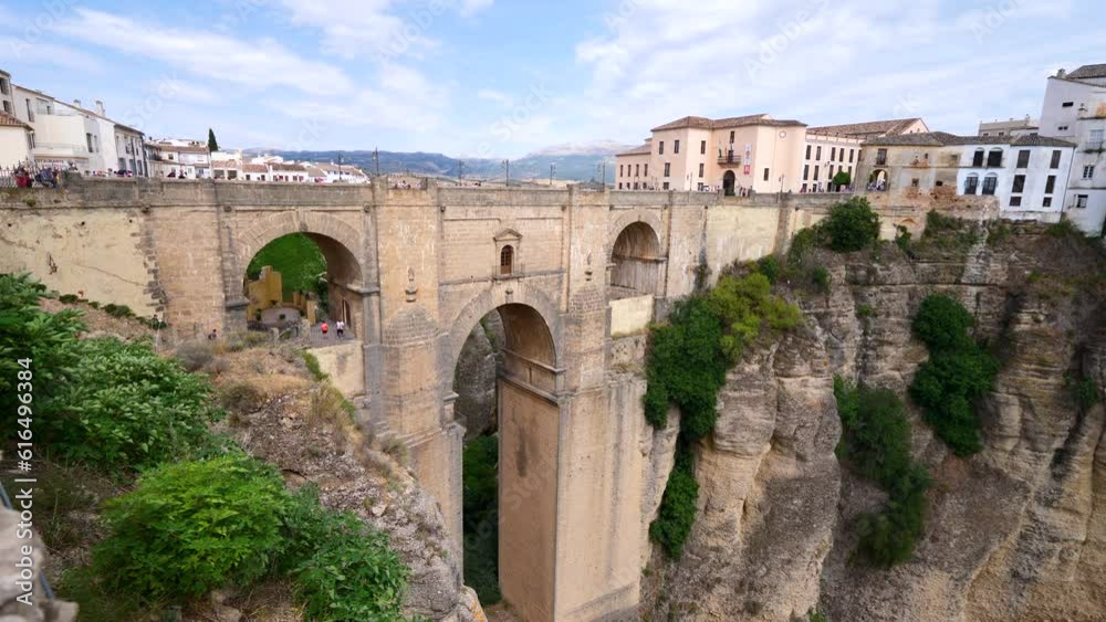 Tourists visit the panoramic landscape views looking over the Punte Nuevo Bridge in the southern region of Malaga in Spain Tourists visit the panoramic landscape views looking over the Punte Nuevo Bridge in the southern region of Malaga in Spain