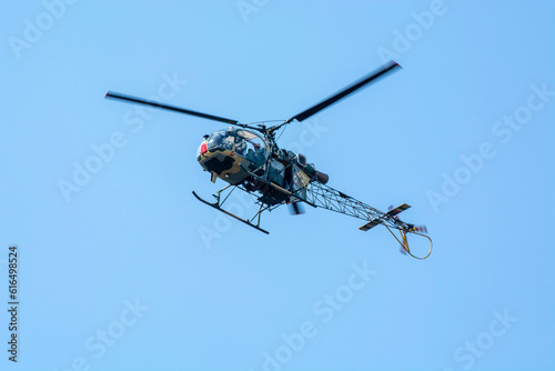 Close-up of flying chopper against isolated blue sky. Indian air force chopper.