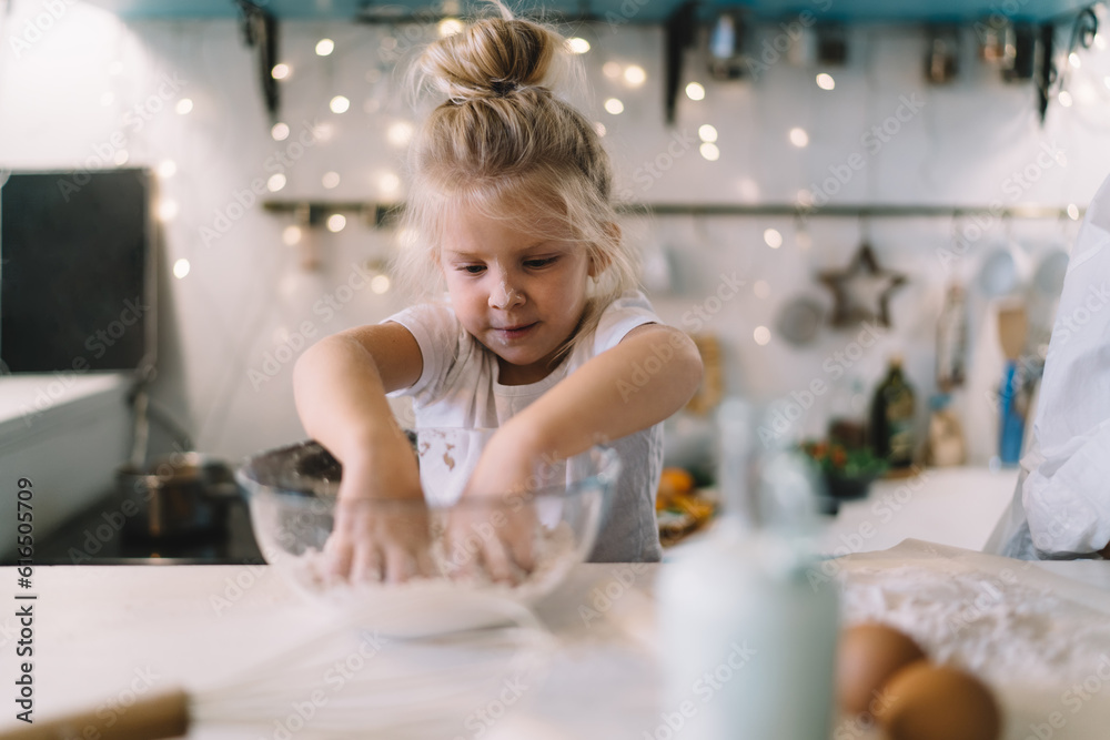 Little girl preparing dough at home Little girl preparing dough at home