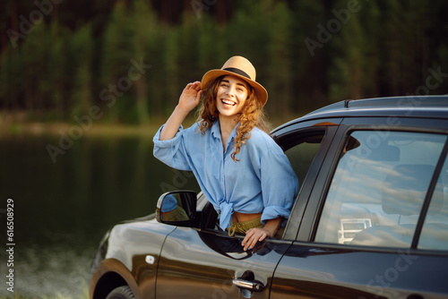 Towards adventure! Young woman is resting and enjoying the trip in the car. Lifestyle, travel, tourism, nature, active life.