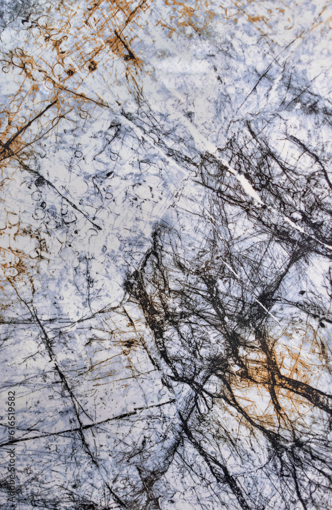 An abstract pattern on white with blue marble, streaked with black cracks and veins.