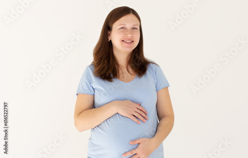 woman enjoying pregnancy, smile, relaxing, hugging belly, isolated on white background © Яна Солодкая