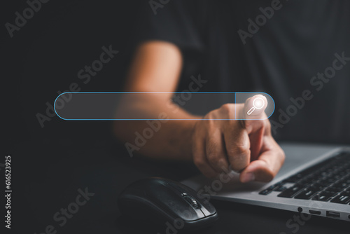 Billede på lærred Businessman's hand touches the button of a blank search bar on a business web banner promoting the concept of search engine optimization