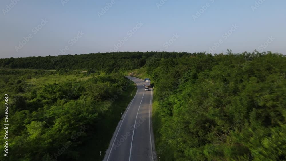 Aerial Drone View truck Drive on Curvy Mountain asphalt Road in Spring Aerial Drone View truck Drive on Curvy Mountain asphalt Road in Spring