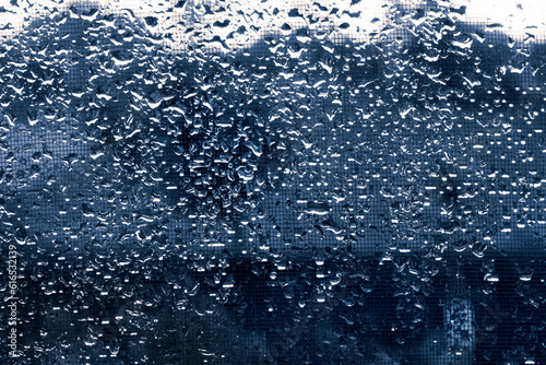 Texture of drops of rain on dark glass. For design and creativity