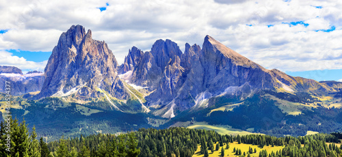 The Alpe di Siusi - Seiser Alm with Sassolungo - Langkofel mountain group in background. Seiser Alm is largest high-altitude Alpine meadow in Europe photo