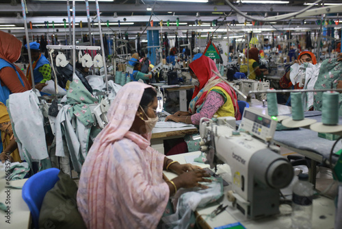 DHAKA, BANGLADESH - FEBRUARY 28, 2022: Women work at a ready-made garment factory in Dhaka, Bangladesh on February 28, 2022.