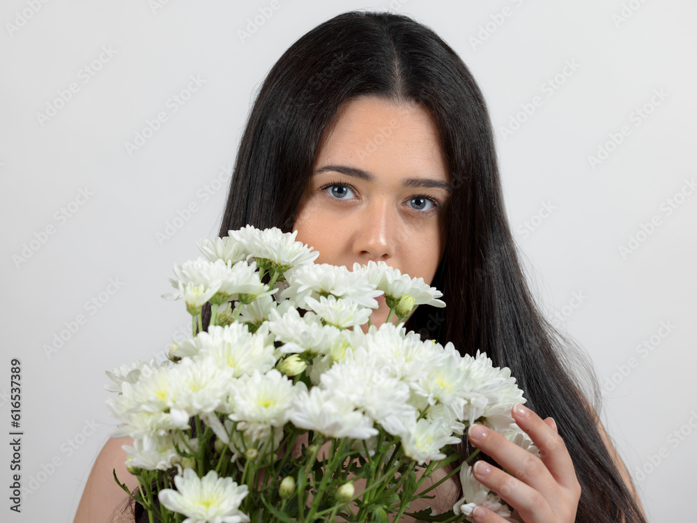 Portrait of young woman with bouquet of white flowers. Portrait of young woman with bouquet of white flowers.