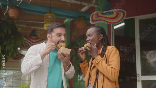 Tourist friends eating street food in Mexico during summer vacations