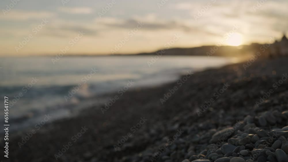 Slow motion low angle shot of sunset on a pebble beach of Nice Slow motion low angle shot of sunset on a pebble beach of Nice