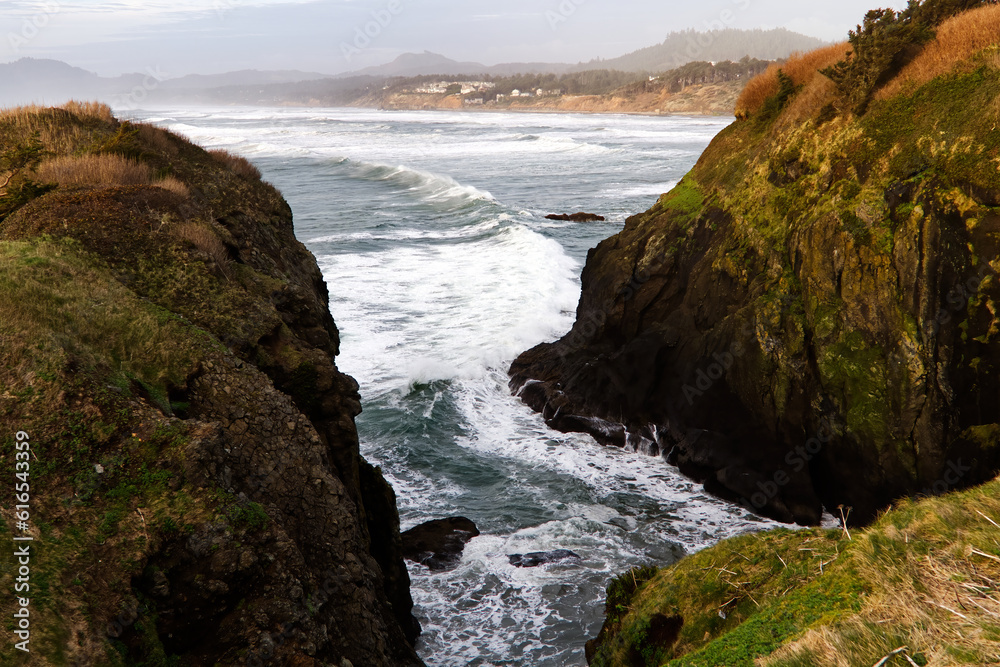 Ocean Waves Surging Between Two Headland Cliffs
