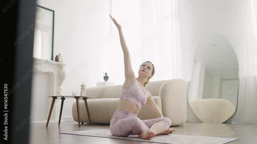 Young Woman Doing Meditation Exercise Stretching Sports Yoga, Bright Room at Home Young Woman Doing Meditation Exercise Stretching Sports Yoga, Bright Room at Home