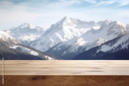 Empty wooden table top against winter snowy high mountains and sky
