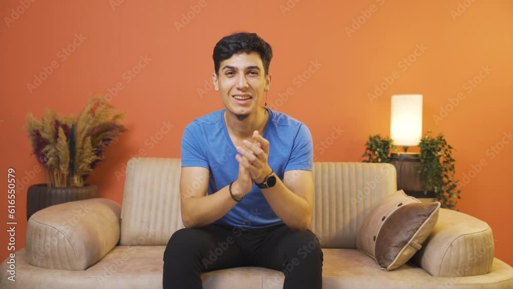 Man clapping excitedly to camera.