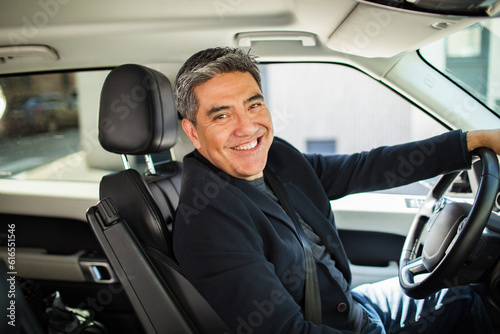 Middle aged latin man driving a car in the city