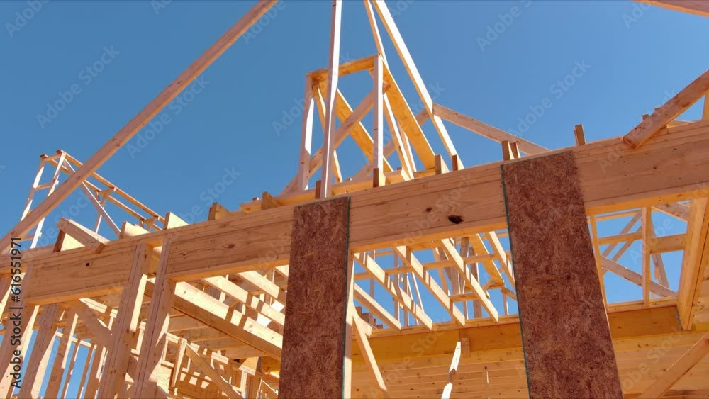 Wooden framing is being used to create structure of new house on a construction site. Wooden framing is being used to create structure of new house on a construction site.