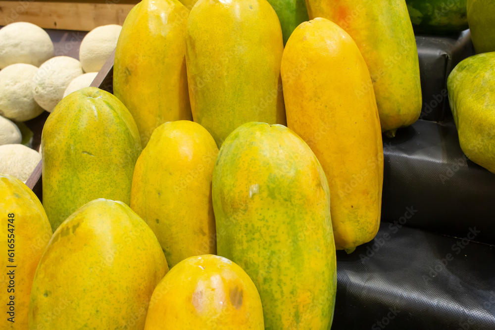 A view of several papayas, on display at a local grocery store.