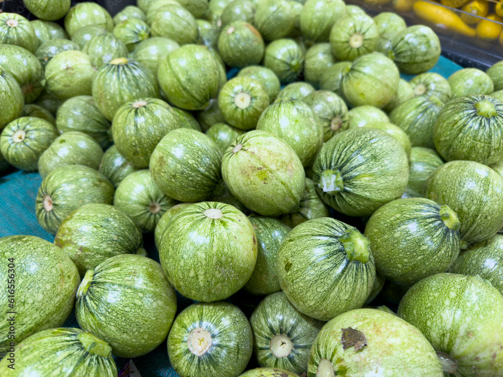 A view of a bin full of cue ball squash, on display at a local grocery store.