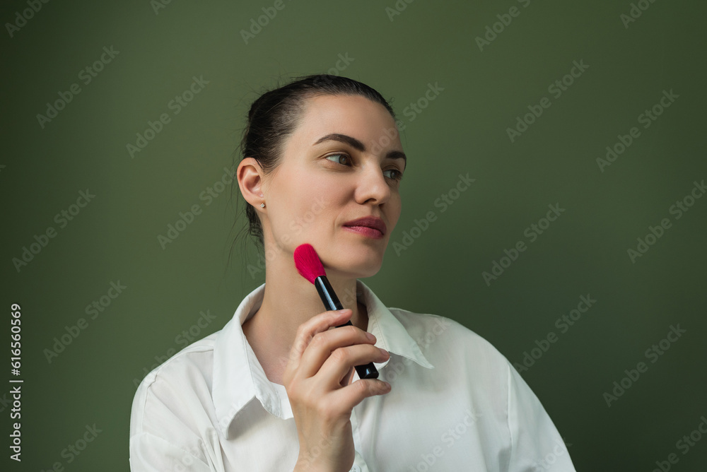 Makeup artist powder and brush . Make up in process. European woman uses makeup brush Makeup artist powder and brush . Make up in process. European woman uses makeup brush
