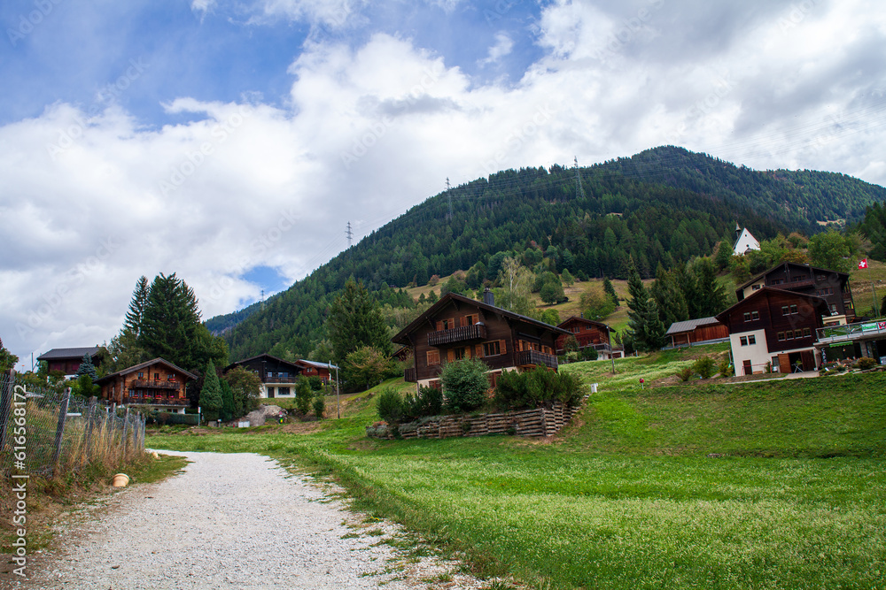 Mountain village in the Swiss Alps on a sunny summer day.