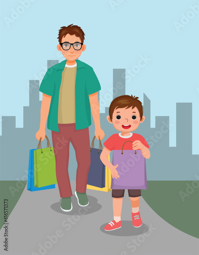 little boy helping his father carrying shopping bag